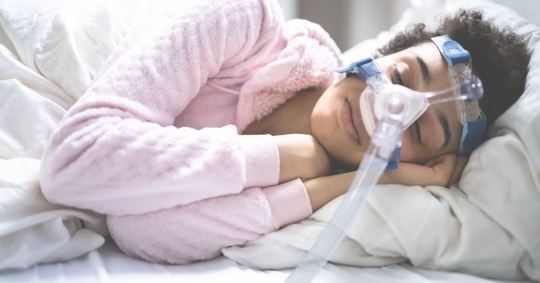 woman sleeping in a CPAP machine